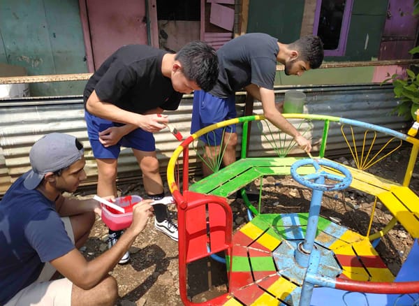 Volunteers painting the playground Volunteers painting the playground
