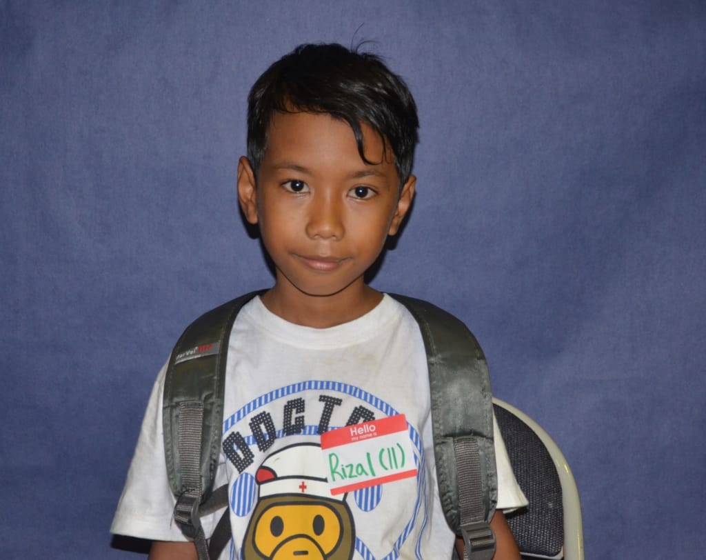 Young boy with backpack smiling