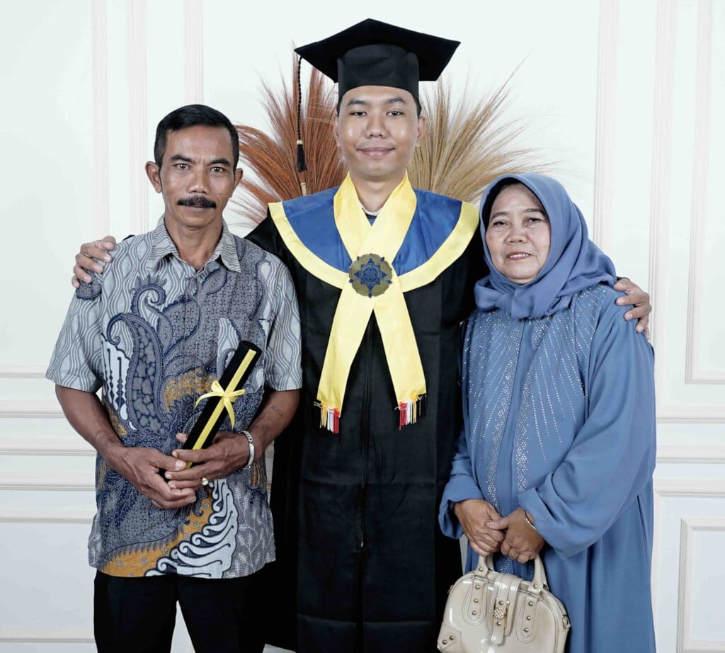 Graduate with parents in traditional attire