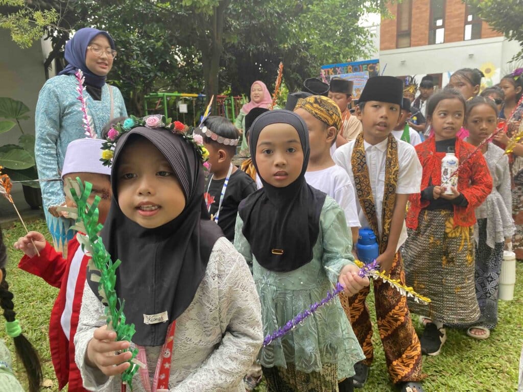 Children in traditional clothing lined up outdoors